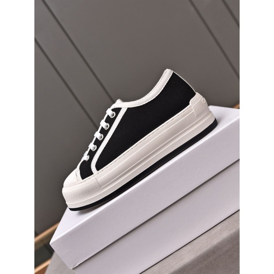 Dior Low-Top Trainer Elevated Box View in black Dior black low-top trainer with white trim resting on shoe box