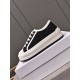Dior Low-Top Trainer Elevated Box View in black Dior black low-top trainer with white trim resting on shoe box