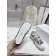 Underside view displaying the patterned rubber outsole tread of Dior platform trainers in beige