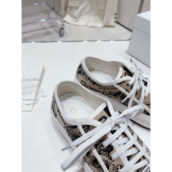 Close-up view of the interior lining and gold logo printed insole of Dior trainers in beige