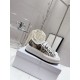 Pair of Dior Walk'n'dior platform trainers in beige resting on a white display box