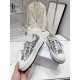 Dior Walk'n'dior Platform Trainer Handheld View in cream and navy Hand holding cream and navy Dior Walk'n'dior Platform Embroidered Trainer