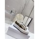 Dior Beige Floral Pattern Platform Trainers - On Box View Dior beige floral pattern platform trainers resting on product shoe box