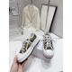 Dior Beige Floral Pattern Platform Trainer - Handheld Display Hand holding Dior beige floral platform trainer showing rubber sole and profile