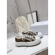 Dior Beige Floral Pattern Platform Trainers - Pair Perspective Pair of Dior beige and black floral pattern platform trainers angled on table