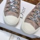 Close-up of signature ribbon laces and eyelet tabs on Dior Walk'n'Dior high-top knit pink trainers