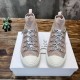 Front view of Dior Walk'n'Dior high-top knit pink trainers showing signature laces and white toe caps