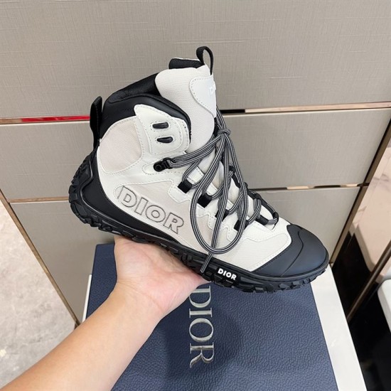 Handheld Lateral Side View in grey and black Hand holding lateral side of grey technical mesh boot showing black rubber trim