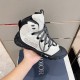 Handheld Lateral Side View in grey and black Hand holding lateral side of grey technical mesh boot showing black rubber trim
