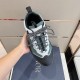 Hand holding top view of Dior Diorizon Technical Mesh Hiking Shoe showing laces in green and grey