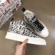 Pair of white and black Dolce & Gabbana Portofino Light Canvas Logo Print Mid-Top Trainers viewed from above