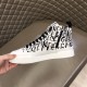 Inner medial side view of Dolce & Gabbana Portofino Light Canvas Logo Print Mid-Top Trainer highlighting the side zip fastening in white and black