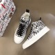 Dolce & Gabbana Portofino Light Canvas Logo Print Mid-Top Trainers angled pair perspective in white and black