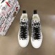 Top-down overhead view of white and black Dolce & Gabbana Portofino Light Canvas Logo Print Mid-Top Trainers