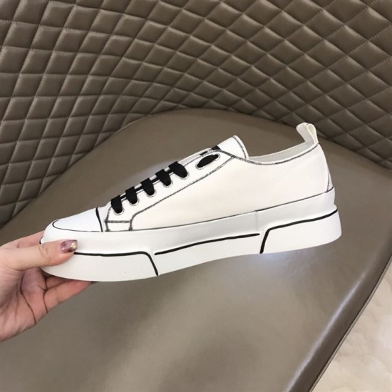 Medial side view of white hand-painted canvas trainer with black outlines