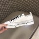 Medial side view of white hand-painted canvas trainer with black outlines