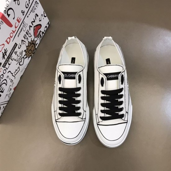 Top-down view of a pair of white hand-painted Dolce & Gabbana canvas trainers in white and black