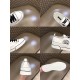Collage of design details including tongue logo, heel pull tab, side logo and embossed sole in white and black