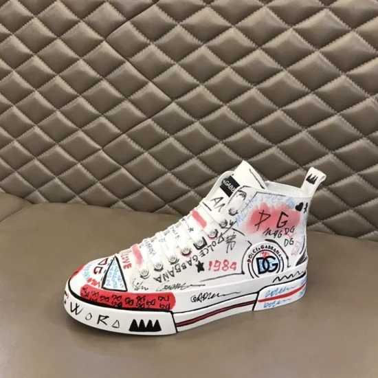 Dolce & Gabbana Graffiti Canvas Mid-Top Trainers Side Profile View in white Dolce & Gabbana white mid-top trainer resting on leather surface showing lateral side detail