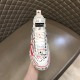 Dolce & Gabbana Graffiti Canvas Mid-Top Trainers Front Profile in white Front view of Dolce & Gabbana white hand-painted trainer showing toe cap and tongue logo patch