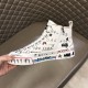 Dolce & Gabbana Graffiti Canvas Mid-Top Trainers Medial Side Zip Detail in white Dolce & Gabbana white graffiti mid-top trainer held showing inner medial zip closure detail