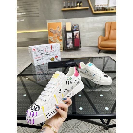 Dolce & Gabbana Portofino Graffiti Print White Leather Trainer held to show ITALY IS BEAUTY motif in white and red