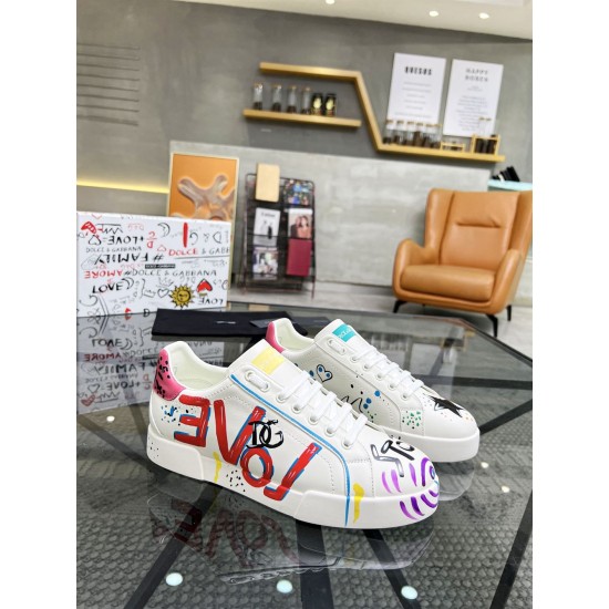 Pair of Dolce & Gabbana Portofino Graffiti Print White Leather Trainers on display in white and red