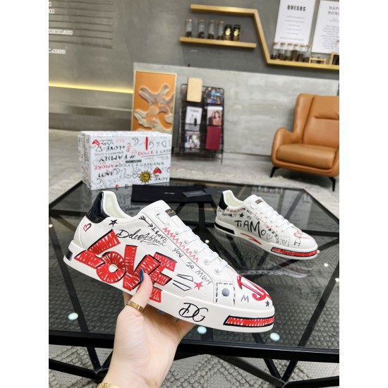 Hand holding Dolce & Gabbana Portofino Love Leather Trainers White Red showing large red LOVE script