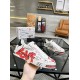 Hand holding Dolce & Gabbana Portofino Love Leather Trainers White Red showing large red LOVE script