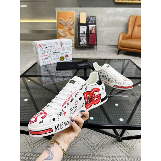 Hand holding Dolce & Gabbana Portofino Love Leather Trainers White Red showing red DG print and Milano text
