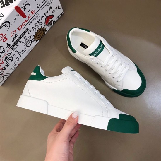 Dolce & Gabbana Portofino Trainers Angled View in white and green Pair of white and green Portofino leather trainers displayed from elevated side angle