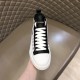 Front perspective of white and black Dolce & Gabbana canvas trainer detailing the eyestays