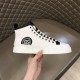 Lateral view of Dolce & Gabbana white mid-top trainer highlighting the circular logo badge
