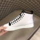 Medial side view of white Dolce & Gabbana mid-top canvas trainer held by hand