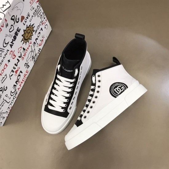 Overhead view of two white and black Dolce & Gabbana Portofino Light trainers placed next to shoe box