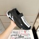 Hand holding Dolce & Gabbana Black Stretch Mesh Slip On Trainer side profile