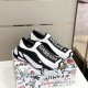 Dolce & Gabbana Stretch Mesh Trainers Front View in white and black Three-quarter view of Dolce & Gabbana white and black slip-on trainers displaying front branding