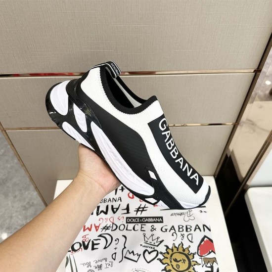 Dolce & Gabbana Stretch Mesh Trainer In Hand in white and black Hand holding single Dolce & Gabbana white and black stretch mesh trainer displaying side and upper details