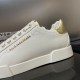 Detailed view of the metallic gold heel counter on Dolce & Gabbana white trainers