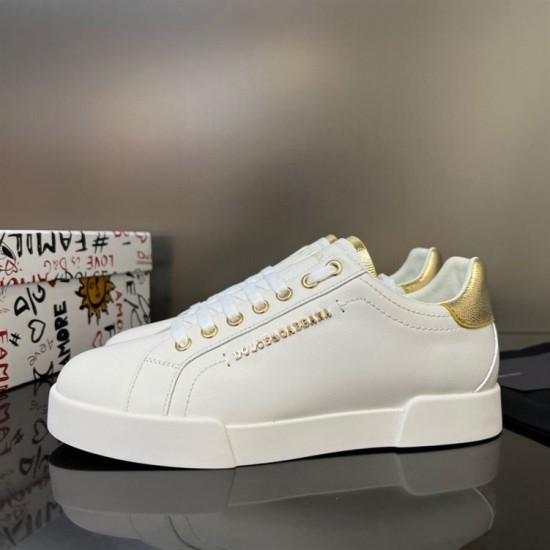 Front oblique perspective of Dolce & Gabbana white and gold leather low-top trainers