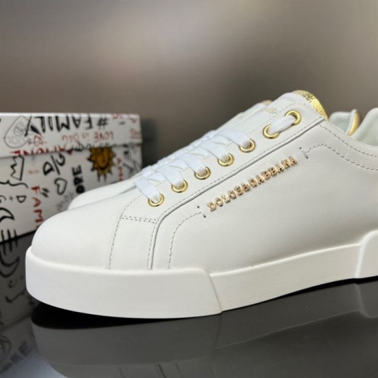 Close-up of gold eyelets and lateral branding on Dolce & Gabbana white trainers
