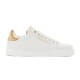 Isolated side view of Dolce & Gabbana white and gold Portofino trainer on white studio backdrop
