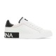 Side view of white Dolce & Gabbana Portofino leather trainer on a plain white background in white and black