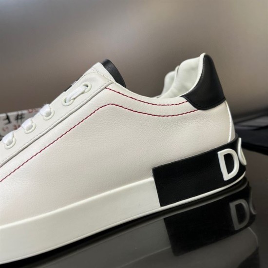 Close-up view of the heel tab and red panel stitching on white Dolce & Gabbana trainers in white and black