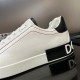 Close-up view of the heel tab and red panel stitching on white Dolce & Gabbana trainers in white and black