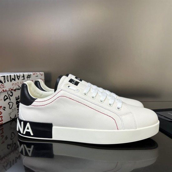 Outer side perspective of white Dolce & Gabbana Portofino trainers with red stitching in white and black