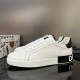 Side profile of white Dolce & Gabbana leather trainers showing heel logo block in white and black