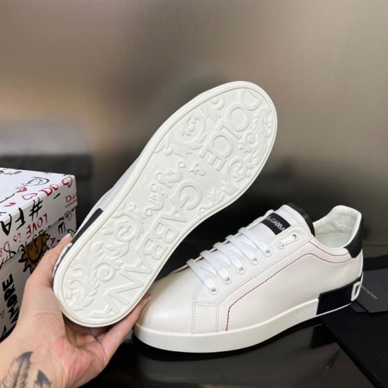 Underside view showing the patterned sole and logo design of Dolce & Gabbana trainers in white and black