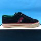 Gucci Off The Grid Black Canvas Trainer Lateral View in black and green Full lateral side view of a single Gucci Off The Grid black trainer resting on a presentation box in black and green