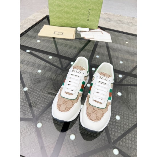 Front elevated view of Gucci white leather trainers with beige monogram canvas toe cap and white laces